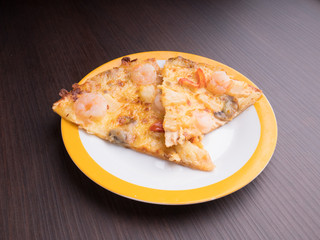 shrimp cocktail pizza with tomato and pineapple on brown wood table