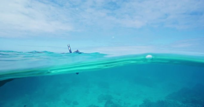 Man snorkeling underwater over tropical coral reef