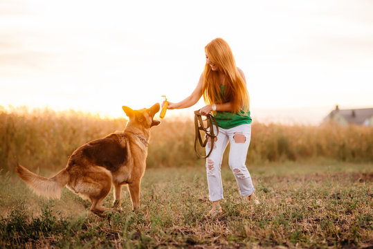 Woman Playing With The Dog