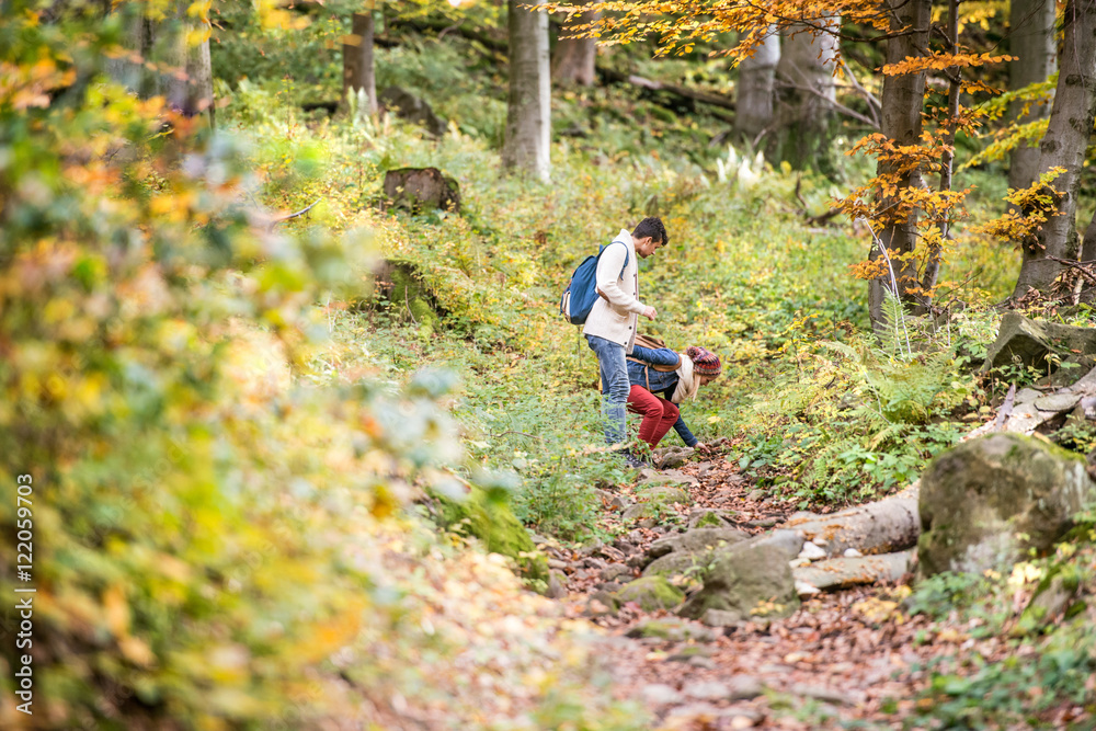 Wall mural beautiful couple on a walk in sunny autumn forest