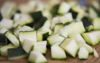 close up on zucchini pieces on wood