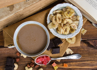 Cup of coffee with dry fruits and chocolate on napkin