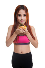 Beautiful Asian healthy girl enjoy eating  hamburger.