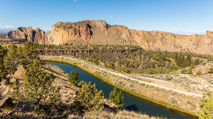 River flowing in the valley against the background of sharp rocks. Smith Rock state park, Oregon