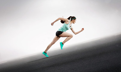 Fototapeta na wymiar female runner sprinting up hill