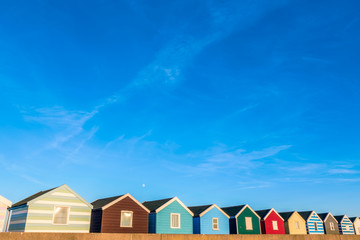 Row of colourful beach huts at sunset in Southwold, Suffolk, UK