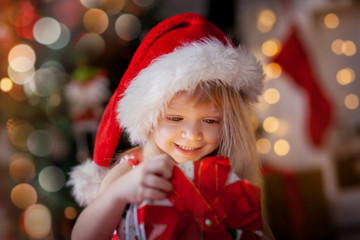 Fototapeta na wymiar Happy Little girl at Christmas Eve 