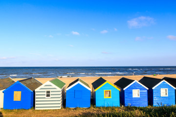 Fototapeta na wymiar Row of blue beach hut at Southwold beach, UK