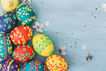Easter eggs and spring flowers on wooden background