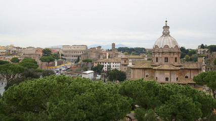 Fototapeta na wymiar Roman Forum and Coliseum in the distance in Rome, Italy
