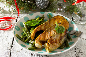 Red fish steaks cooked on the grill and green beans on a festive