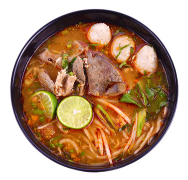 Noodles in Thai spicy tom yum soup with pork