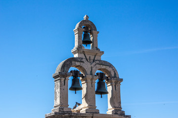 3 Bells in front of a blue sky