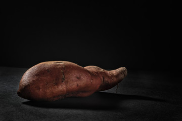 Sweet potato on black background