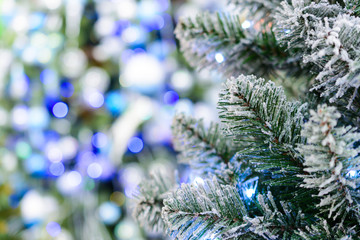 branch of an artificial Christmas tree strewn