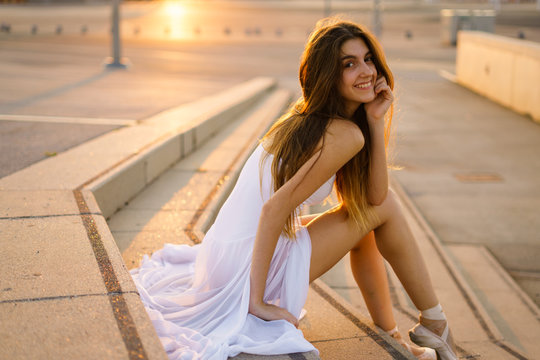 Young ballet dancer in white dress