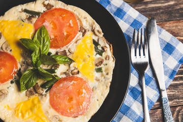 Omelet with tomatoes, parsley and feta cheese
