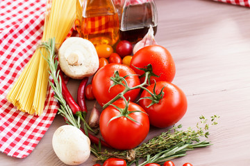 Ingredients for pasta: spaghetti, vegetables and spices on the old table.