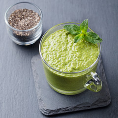 Matcha green tea chia seed pudding, dessert with fresh mint and coconut. Healthy breakfast