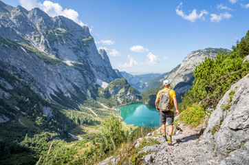 Mountaineer hiking in the mountains near Dachstein, Austria - obrazy, fototapety, plakaty