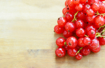 Health Benefits of Redcurrant.
Redcurrant on wooden background with Space for write a message.
