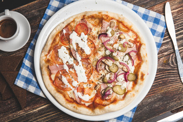 Delicious fresh pizza served on wooden table with coffee