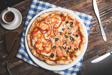 Delicious fresh pizza served on wooden table with coffee