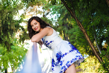 Beautiful young woman strolling through the summer garden. amazing view