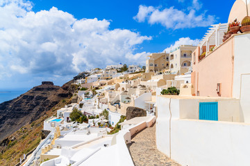 Path in beautiful Firostefani village with typical Greek white a