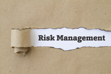Risk Management written under burnt torn paper.