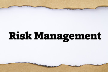 Risk Management written under burnt torn paper.