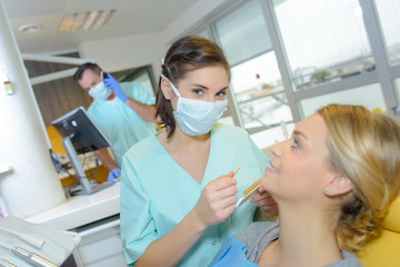 Fototapeta na wymiar dentist curing a woman patient in the dental office