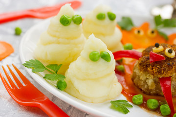 Mashed potatoes ghosts with green peas eyes, hot dinner dish for