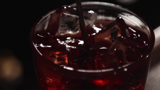 Mixing alcohol with ice in slow motion