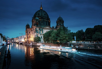 Fototapeta na wymiar Berlin Cathedral with excursion boat on Spree river, Berlin, Ger