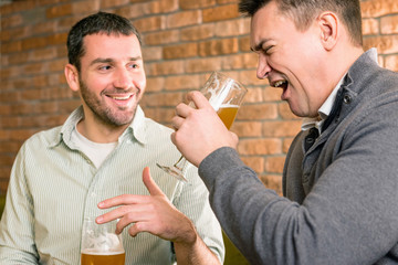 Friends drinking beer in a pub