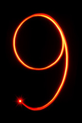 red light painting number nine on black background