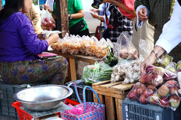 Grocery shoppers buying from a street vendor in Bhutan