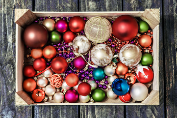 Christmas decoration in a box on a wooden floor