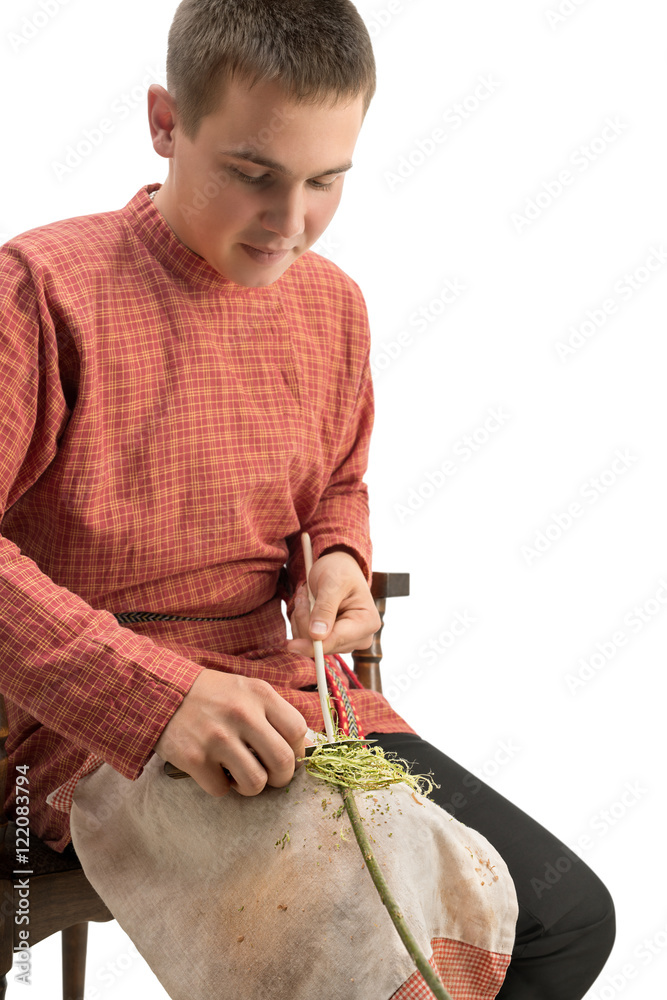 Wall mural Craft. Young boy barks a twig, isolated on white