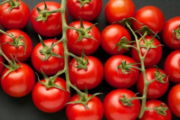 Fresh tomatoes on black background