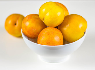 Yellow plums isolated on white background