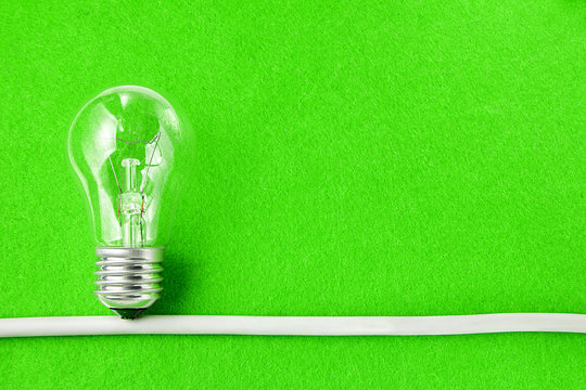Concept ecology. Light bulb on green background with copy space