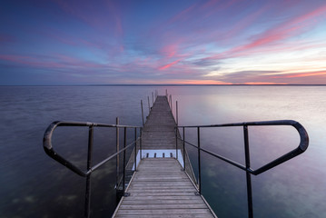 Wooden jetty for sailboats in autumn sunlight. Port of Kuznica on Hel Peninsula. Poland. 