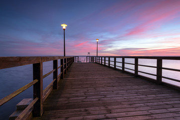 Obraz premium Small wooden pier at sunset time Port of Kuznica on Hel Peninsula. Poland. 