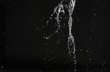 Splash of water with air bubbles. Close up. Black background