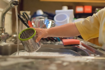 Child washing dishes
