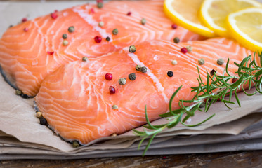 Detail of Raw Salmon Fish Fillet with Lemon, Spices and Fresh Herbs Ready for Cooking