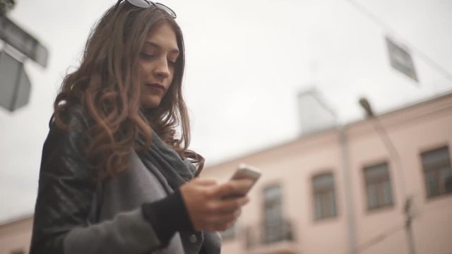 Woman using smartphone in the European city