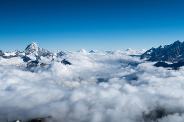 Fototapeta na wymiar Mountain peaks above the clouds